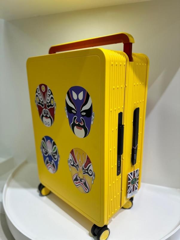Yellow custom-printed suitcase with opera mask artwork